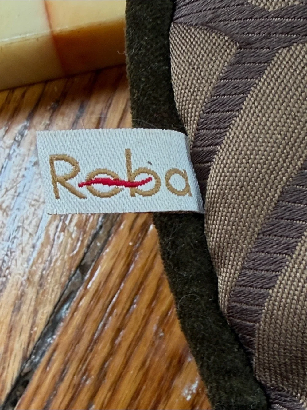 Reba green velour pillow with embroidered scroll design on front.